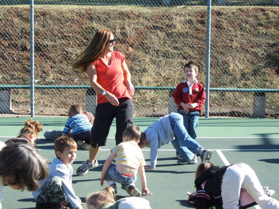 teacher and kids doing movement on a playground